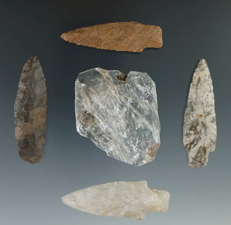 Set of five flake artifacts including three stemmed points, an ovate bi-face and a large quartz crys