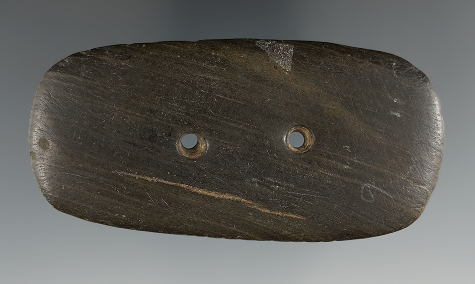 3 5/8" Hopewell Ovate Gorget that is tallied. Made from Slate. Ex. Warner, Donaldson.