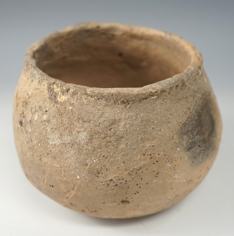 4 3/4" wide by 3 5/8" tall pottery vessel with a restored probe hole - Kentucky.