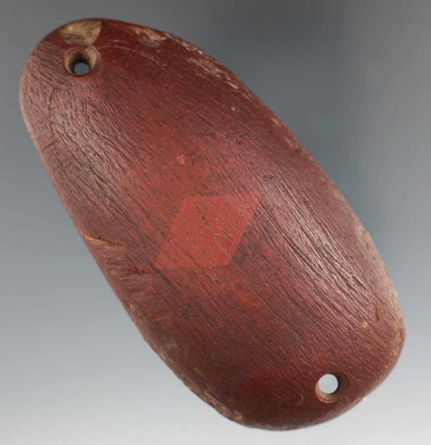 3 13/16" Humped Gorget made from a red Slate from the eastern seaboard area.Ex. S. Puttera.