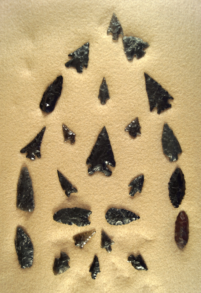 Group of approximately 24 assorted obsidian arrowheads, some are restored, found in Oregon.