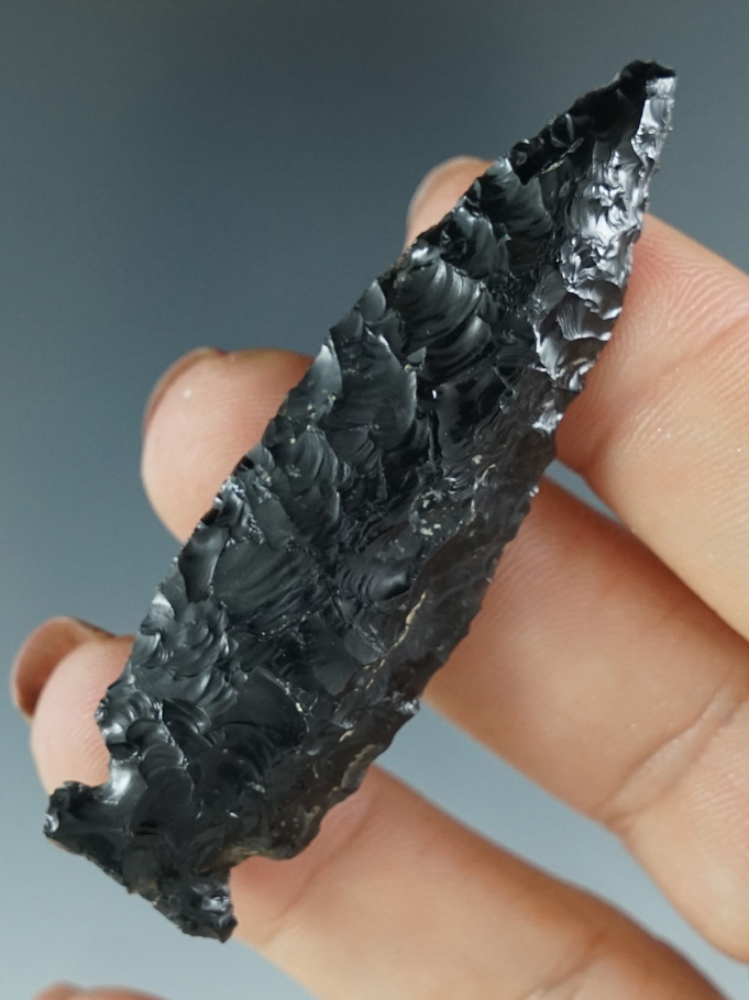 Very nice flaking and style on this 2 12" Obsidian Sidenotch found in Oregon.