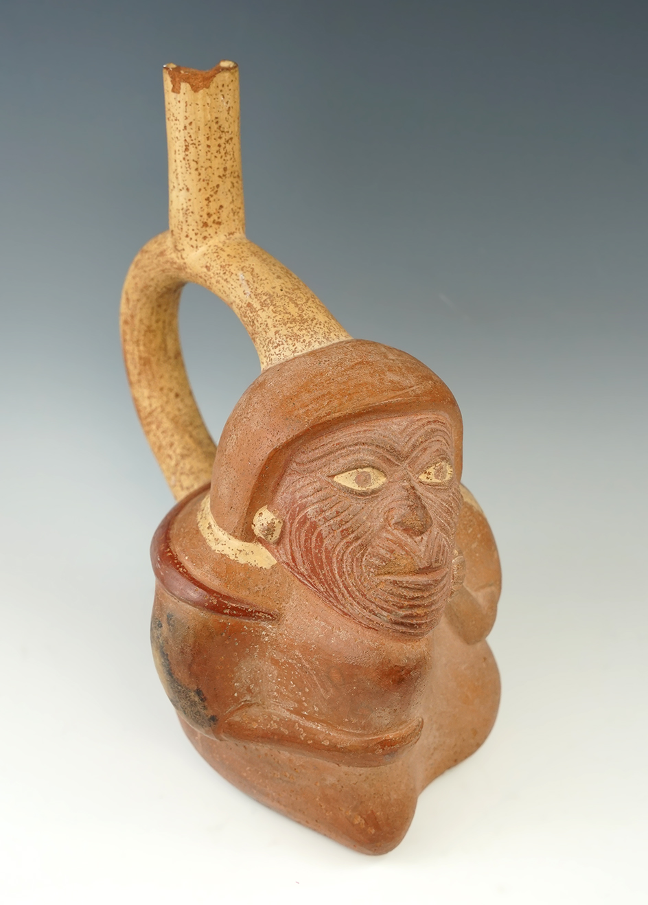 8 3/4" tall Moche III stirrup bottle in very nice condition. Effigy features a human with a goiter.