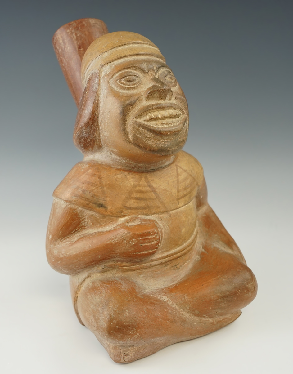 8 7/8" tall Moche seated dignitary pottery vessel with a probe hole in back and some restoration.