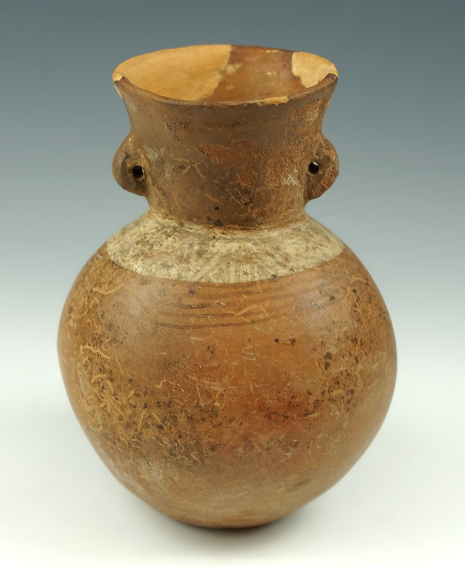 6" tall by 4 3/8" wide Moche canteen vessel found in Peru. Some restoration to rim area.