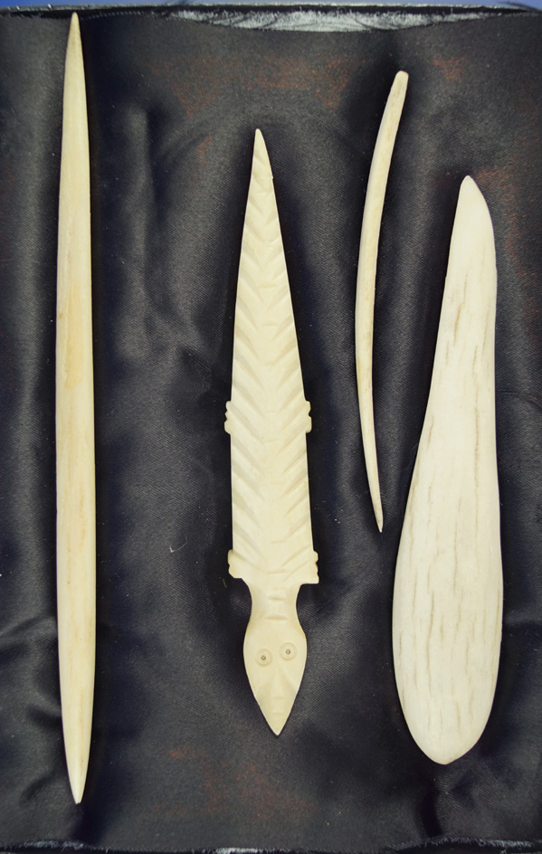 Group of contemporary carved bone items including Awls and effigies from the Northwest Coast. Displa