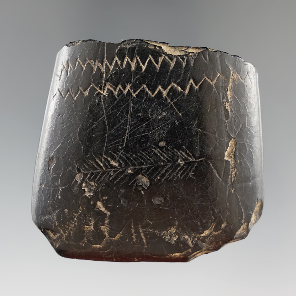 2 1/8" Highly engraved, lower half anciently broken Trapezoidal Pendant. Ex. Meuser, May.