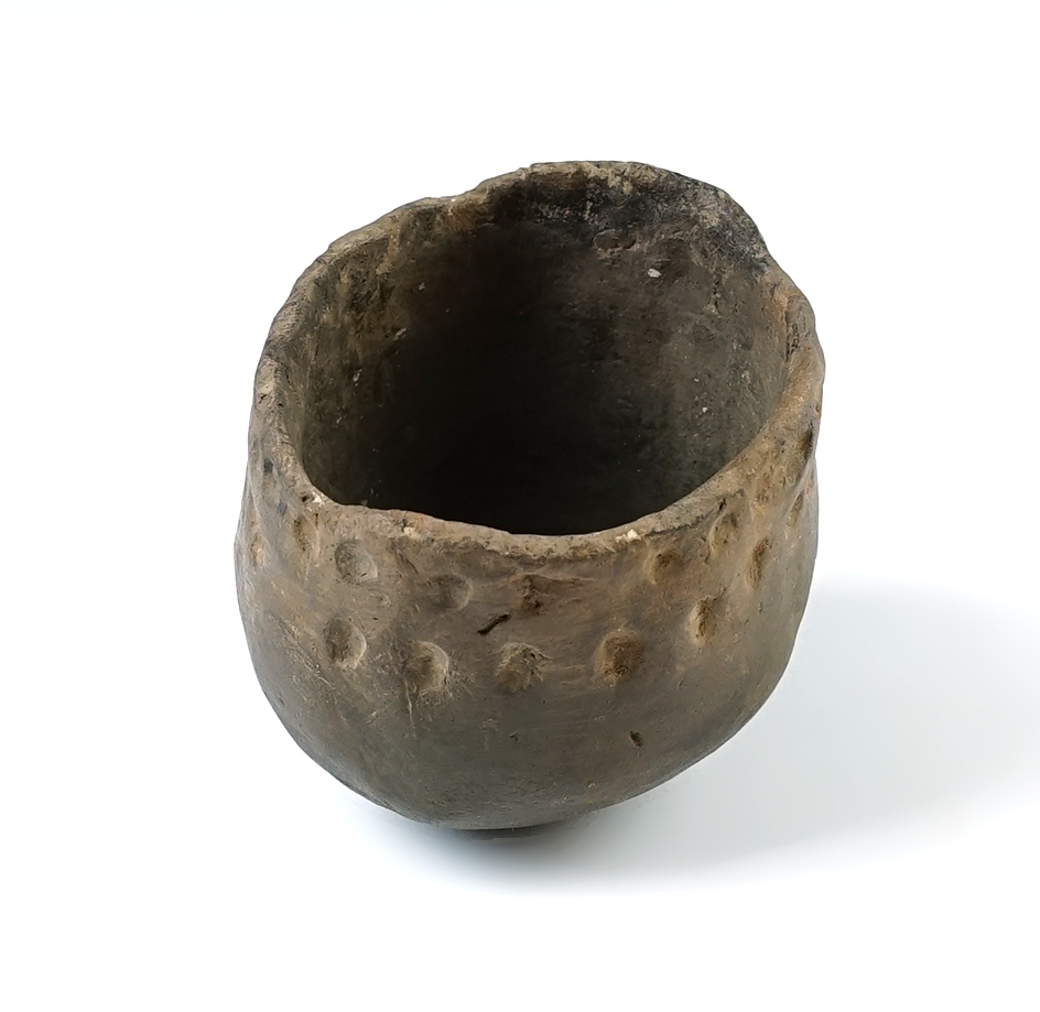 2 5/8" tall x 2 7/8" wide pottery jar in solid condition. Found at the Warren Site, New York.