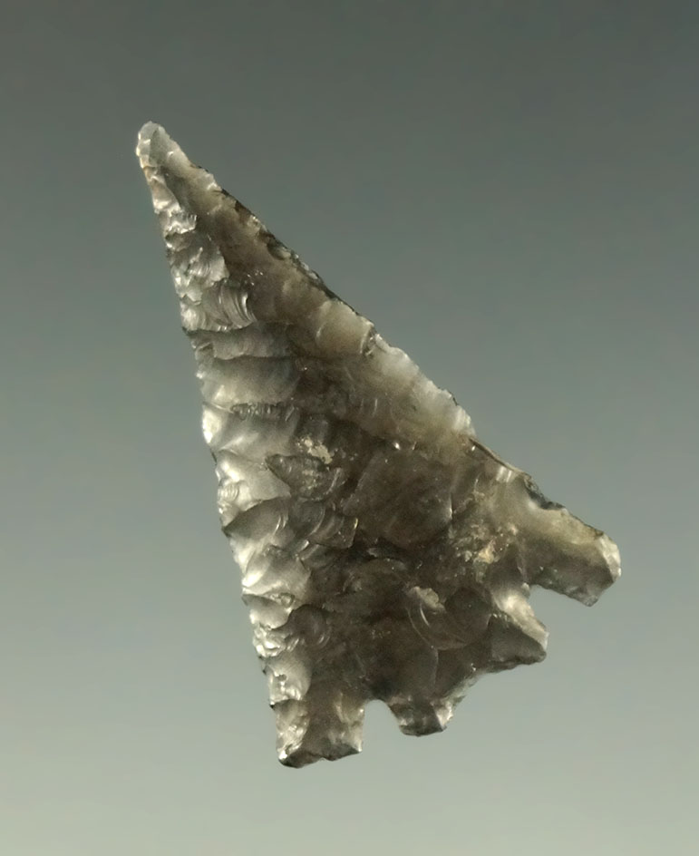 1 3/16" Eastgate split-stem - translucent obsidian - very thin and well flaked. Ex. Museum.