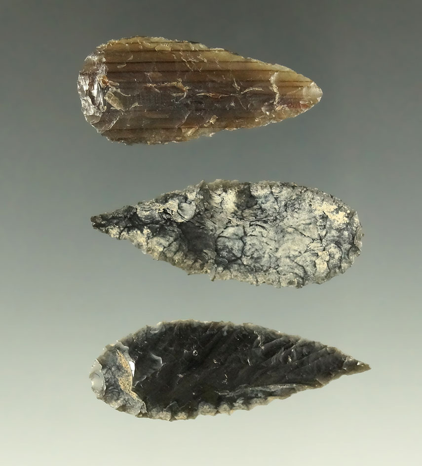 Set of three well made and heavily patinated obsidian and Petrified Wood Cascade points