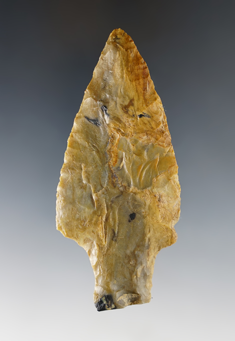 3 3/4" Archaic Stemmed point made from multi-colored Plum Run Flint. Found in Ohio.