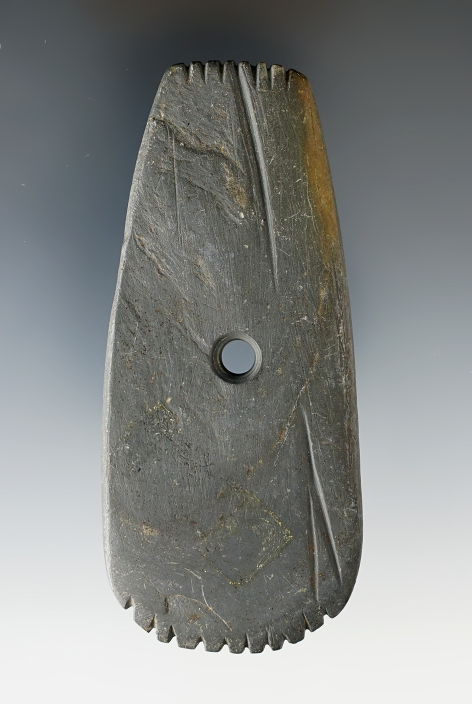 3 3/4" Slate Hopewell Trapezoidal Pendant that is fringed on both ends and grooved. Knox Co., Ohio.