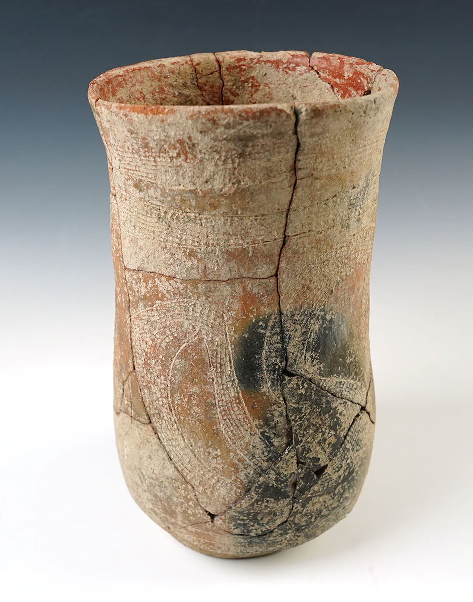 8 1/4" tall by 4 1/2" wide pedestal base Pottery Vessel with heavily engraved exterior design. 