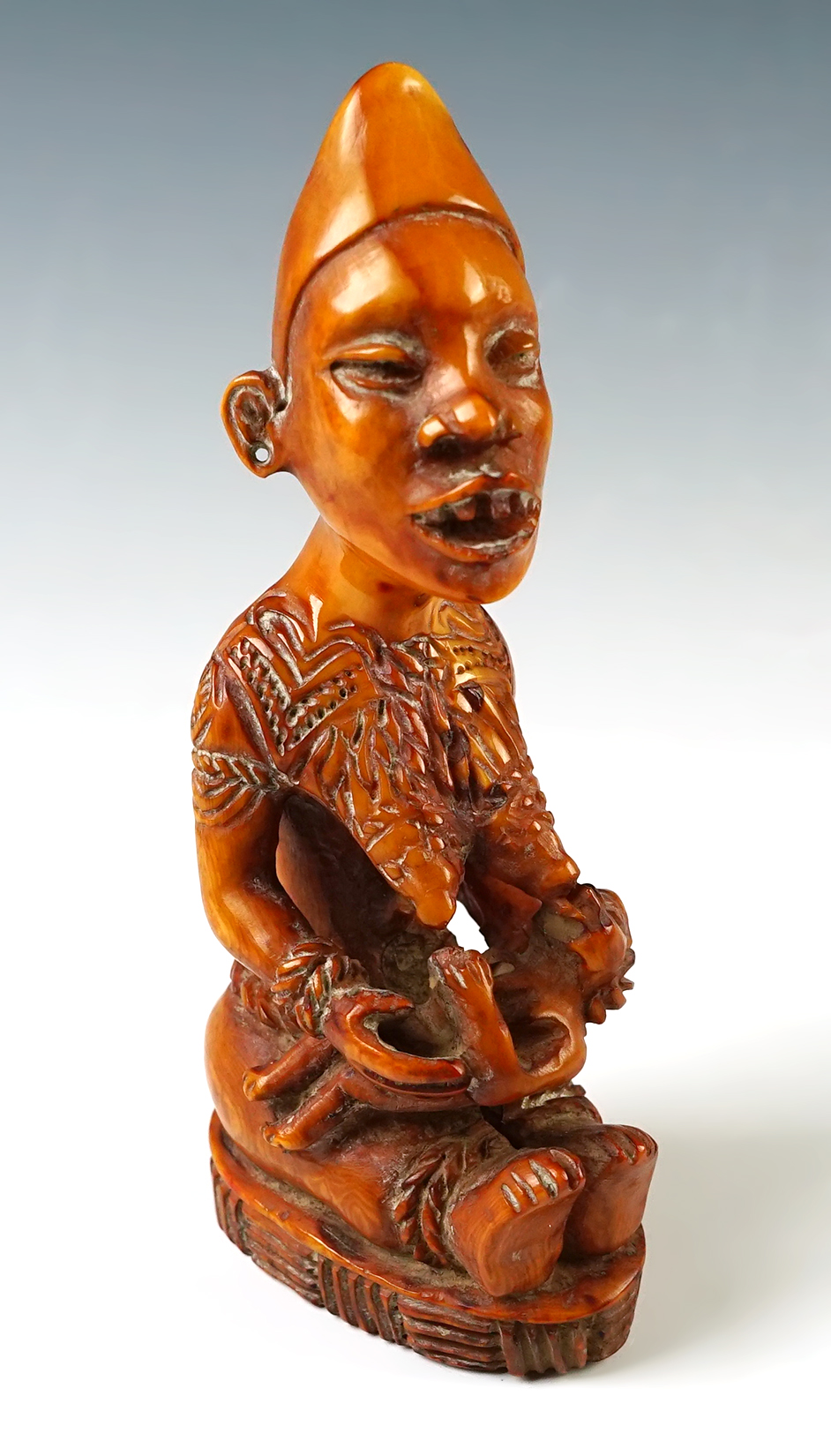 Exceptional craftsmanship on this well designed 5" tall carving of a mother feeding child. 